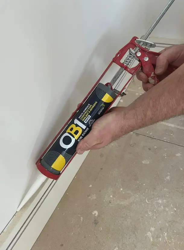 Professional caulking and grouting with sealant gun for home repair